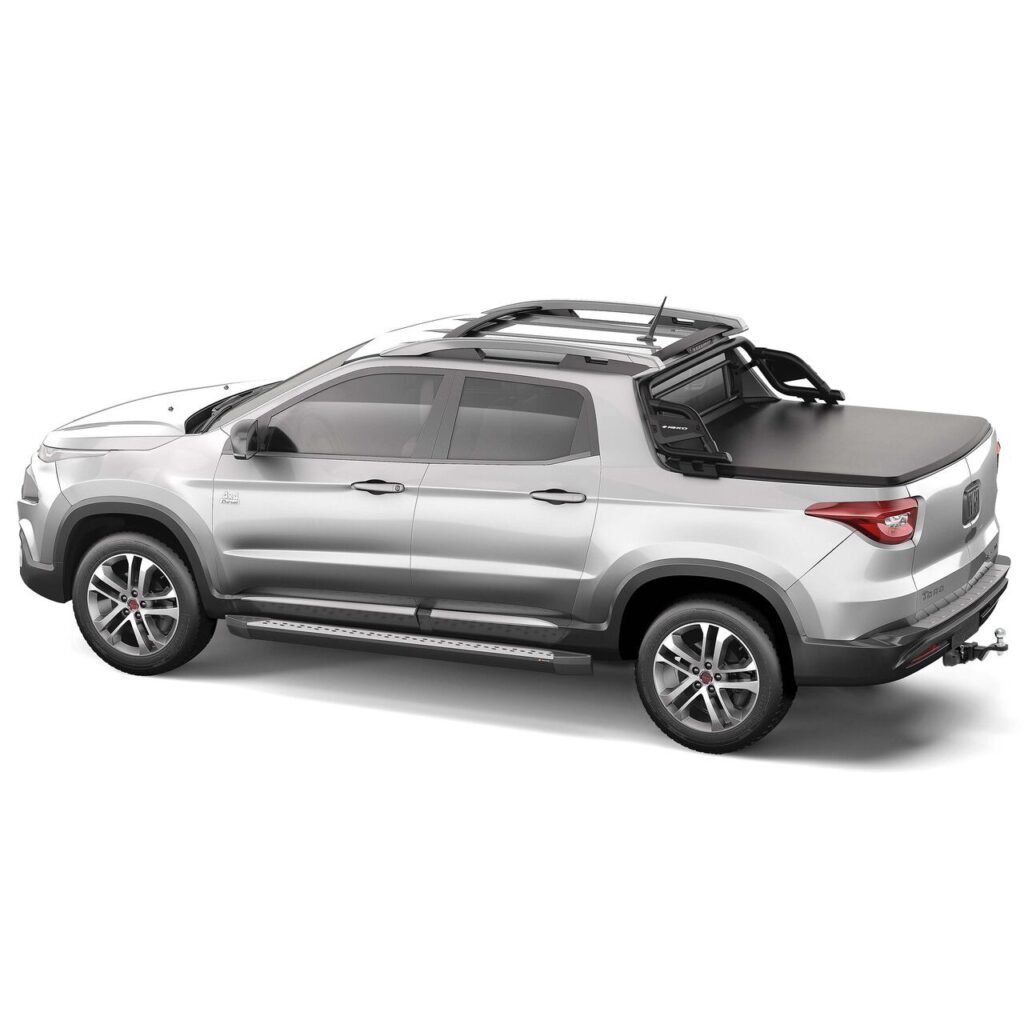 Caminhonete prata com cabine dupla, rack de teto, estribos e rodas de liga leve. Destaque para a melhor capota marítima Fiat Toro, ideal para proteção e estilo no transporte.